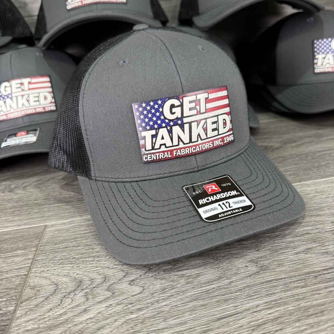 Charcoal and black Richardson 112 trucker hat with a full color UV printed patch showing a customer's American flag company logo