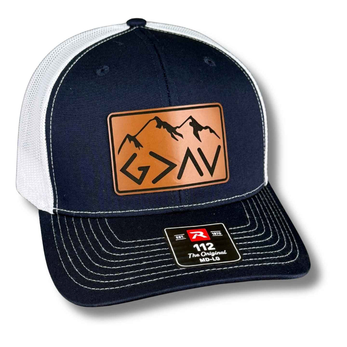 Navy and white Richardson 112 trucker hat with a God Is Greater Than the Highs and Lows mountain leatherette patch